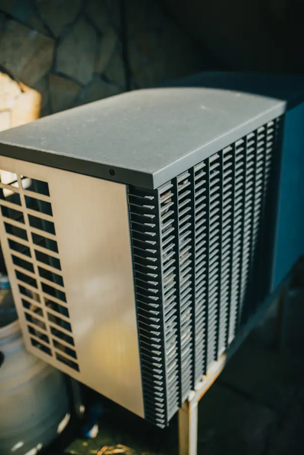 Outdoor air conditioner unit installed in residential garden space