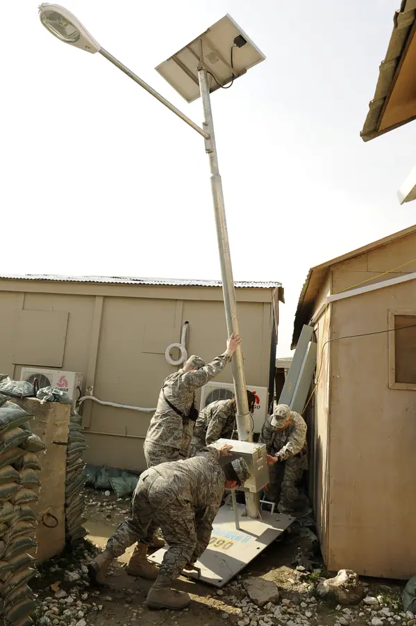 U.S. Airmen raise pole with a solar powered light at Bagram Airfield, Afghanistan, Feb. 23, 2010 100223-F-PI632-161