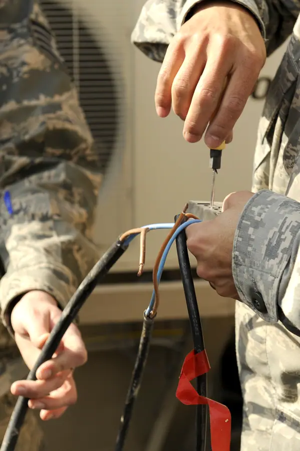 U.S. Airmen works on the wiring of a solar powered light at Bagram Airfield, Afghanistan, Feb. 23, 2010 100223-F-PI632-153