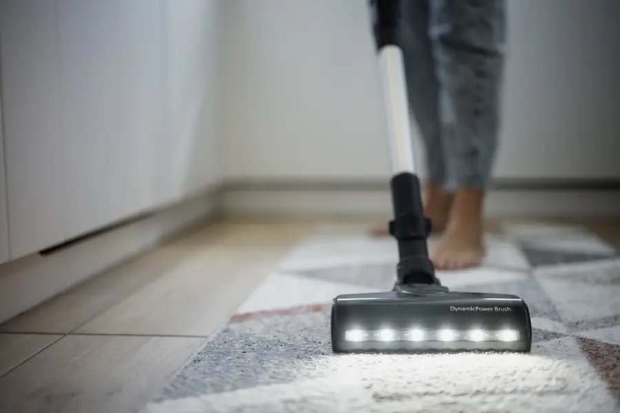 Cleaning the floor with a vacuum cleaner in a home setting