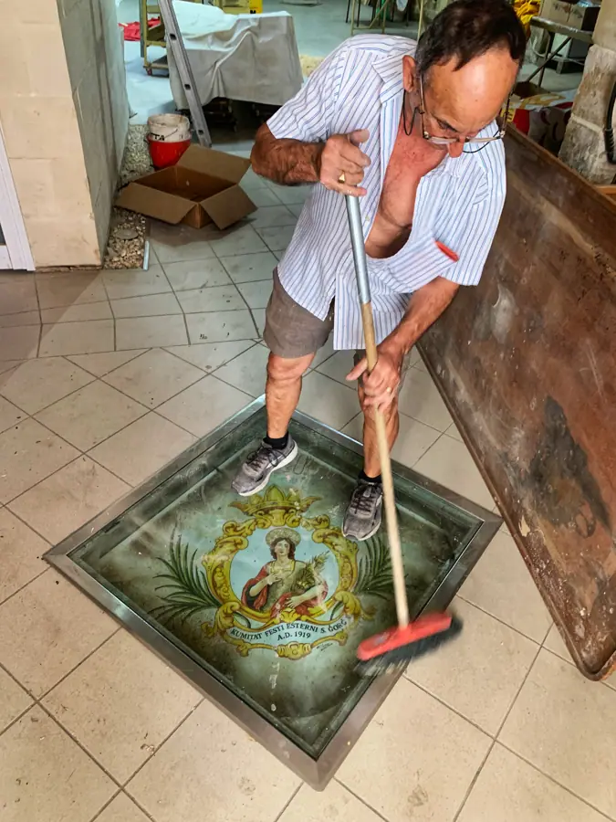 The handy man of the parish is cleaning old tile of St George. Qormi