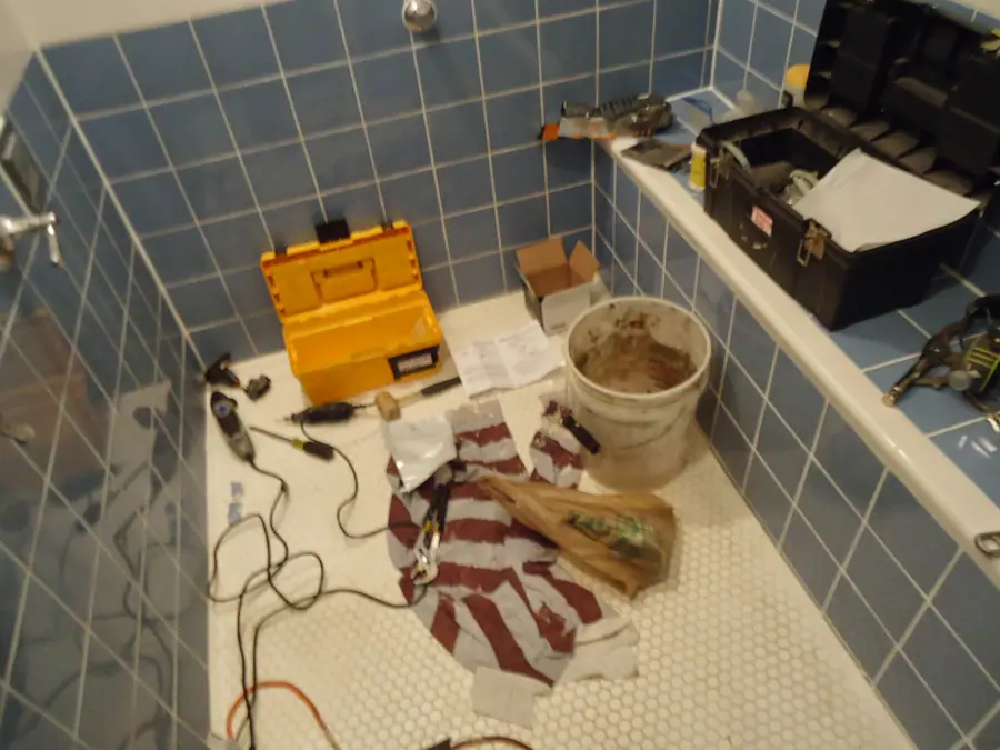 Kohler shower valve replacement tools on floor of shower
